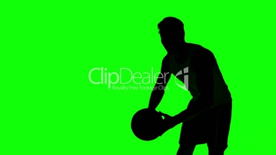 Silhouette of a man throwing a basketball on green screen
