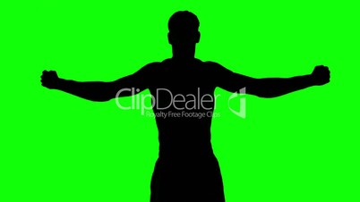Silhouette of a man stretching arms on green screen