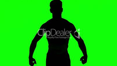 Silhouette of a man tensing muscles on green screen