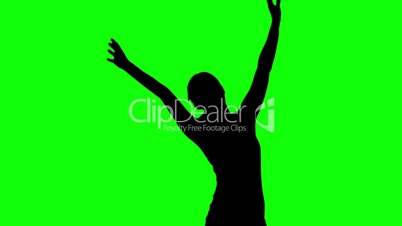 Silhouette of woman raising arms on green screen