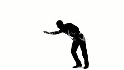 Silhouette of man with a tie breakdancing on white background