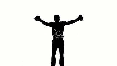 Silhouette of man jumping and boxing on white background