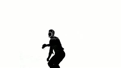 Silhouette of a jumping man turning on white background