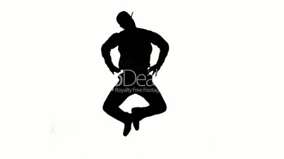 Silhouette of a man jumping with hands on hips on white background
