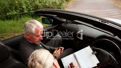 Couple in a silver car