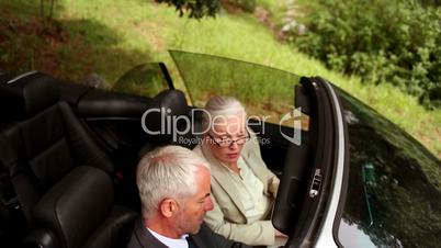 Couple in a silver car