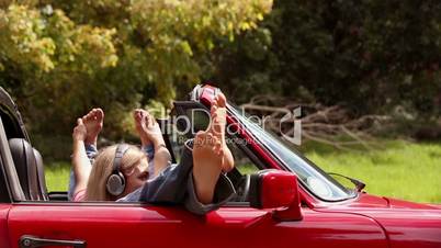 Girls listening to music in a red car