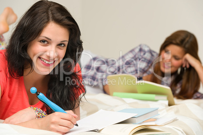 Smiling female students preparing for exam