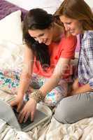 Laughing girls chatting with friends online