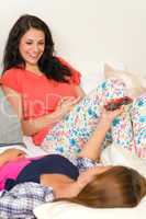 Resting female teens having fun with smartphone