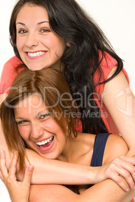 Pretty teens laughing and smiling at camera