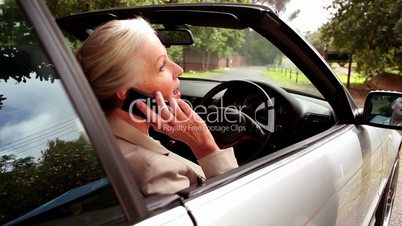 Woman on the phone sitting in her car