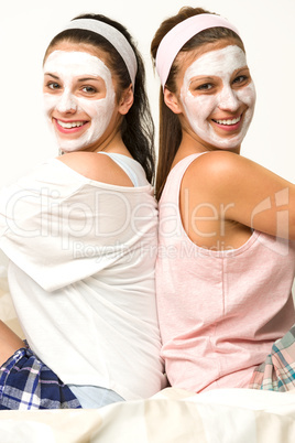 Two female friends with facial mask