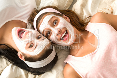 Crazy girls with facial mask lying bed