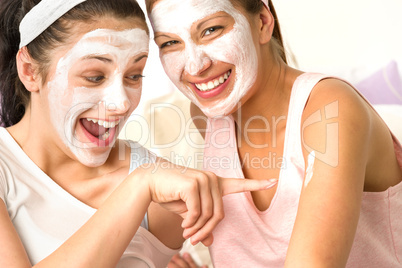Caucasian girls wearing peeling mask having fun