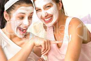 Caucasian girls wearing peeling mask having fun