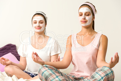 Meditating women wearing white facial mask