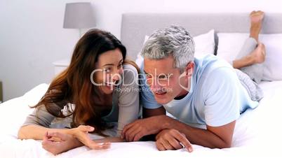 Couple talking on a bed