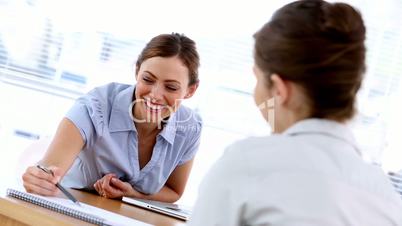 Woman explaining contract to new employee