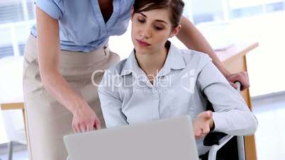 Businesswoman in a wheelchair working with a laptop