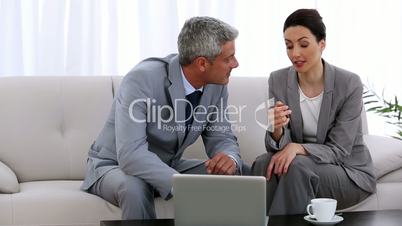 Business partners working on a laptop