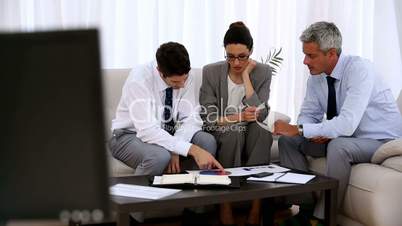 Group of business people working on a pie chart