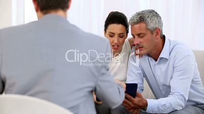 Couple signing a contract made by a salesman