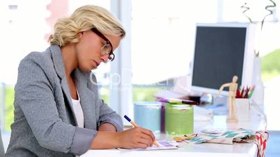 Creative woman surrounding something on document