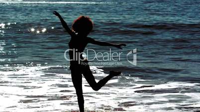 Woman dancing while she is into the sea