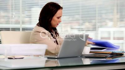 Businesswoman looking for a folder