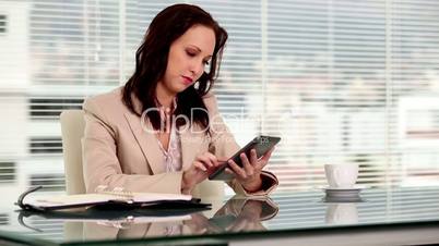 Serious businesswoman using a tablet