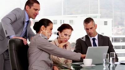 Businesswoman pointing at the screen of a laptop