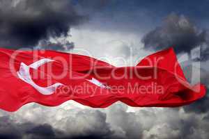 waving flag of turkey against storm clouds