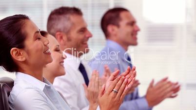 Cheerful business people applauding