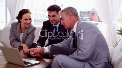 Business people pointing at a laptop