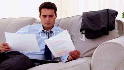 Concentrated businessman working on a couch