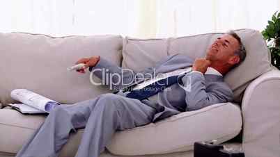 Businessman lying on couch