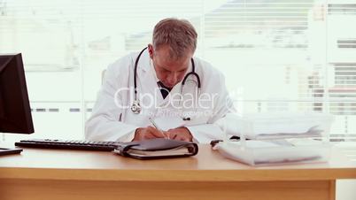 Serious doctor writing