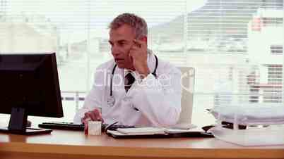 Doctor sitting behind his desk