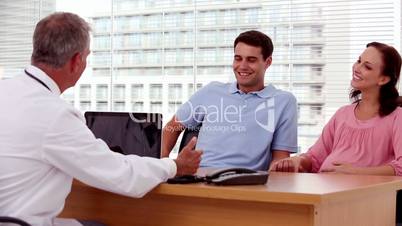 Doctor explaining something to a couple patients