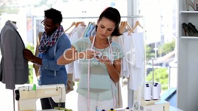 Fashion designers working together on a jacket