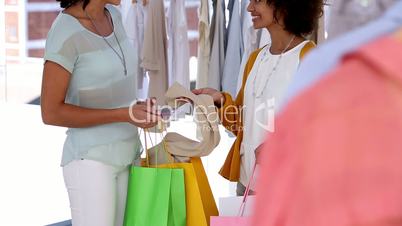 Woman with shopping bags talking with a friend