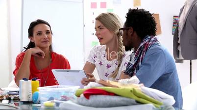 Fashion designers working with a tablet