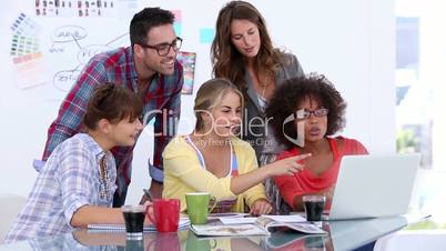 Group of designers working on a laptop