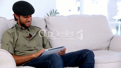 Man using tablet pc on the couch