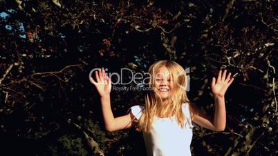 Cheerful girl jumping on a trampoline