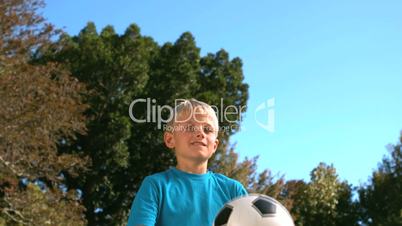 Little boy heading a football