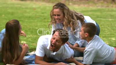 Happy family playing together in a park