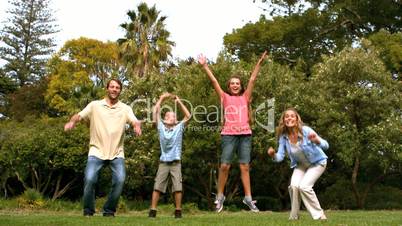 Happy family jumping together