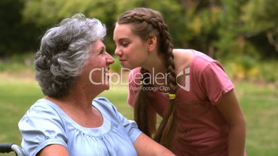 Little girl kissing her grandmother